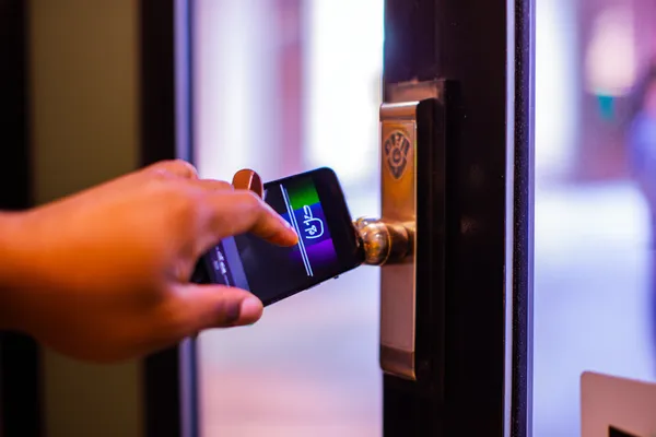 A woman smiling while playing online games on her laptop, surrounded by neon casino elements, showcasing 7C777’s diverse game collection.