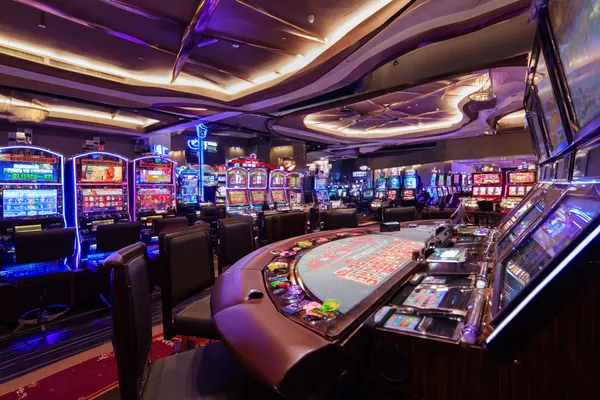 A glowing roulette wheel with cascading chips, symbolizing the engaging live and instant-win games available on 7C777.