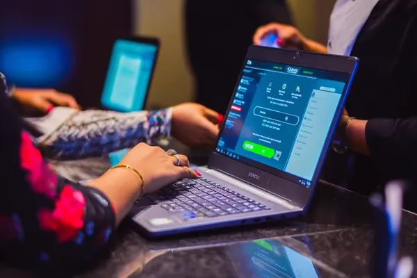 A confident dealer surrounded by casino chips inviting players to access their 7C777 account, reflecting quick and easy login options.